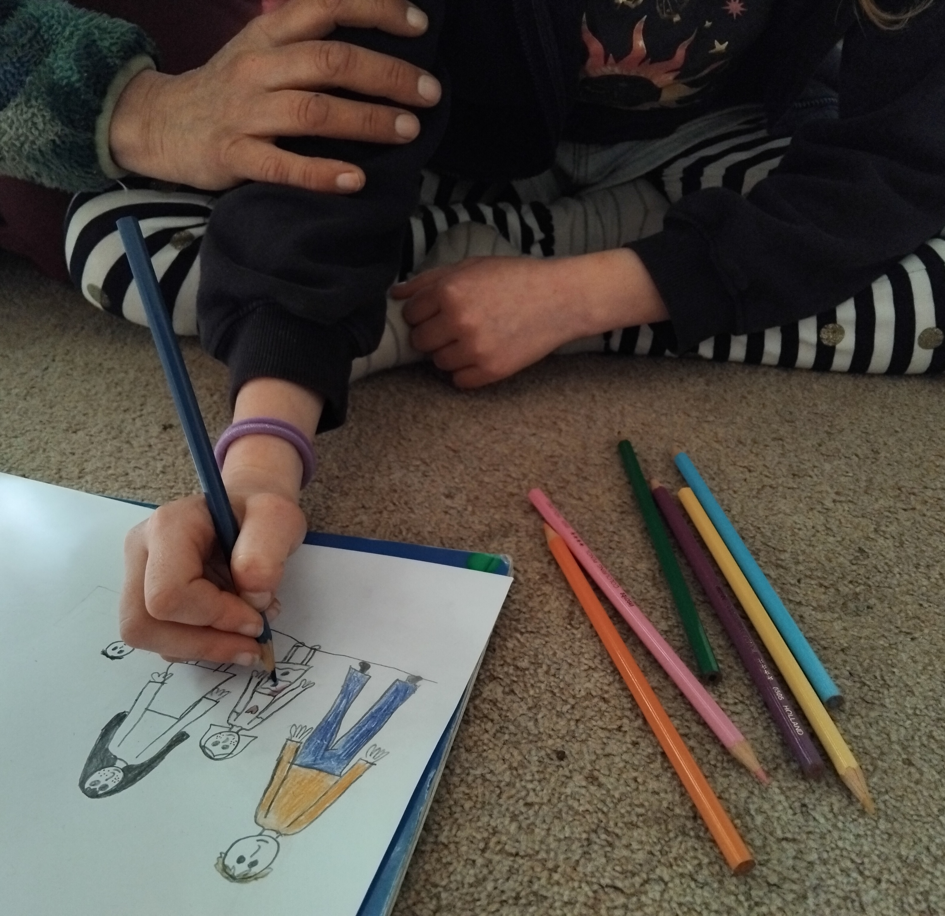 Image of child drawing a family