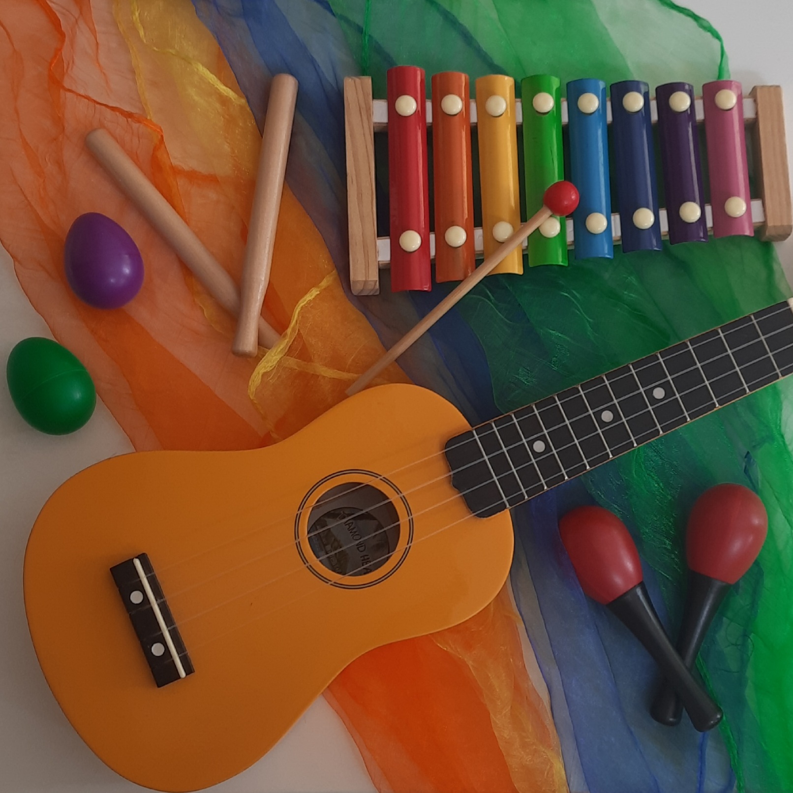 Kids musical instruments on a colourful scarf